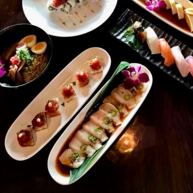 Assortment of Kenzo Thai & Sushi dishes, including ramen, nigiri, and various sushi rolls.