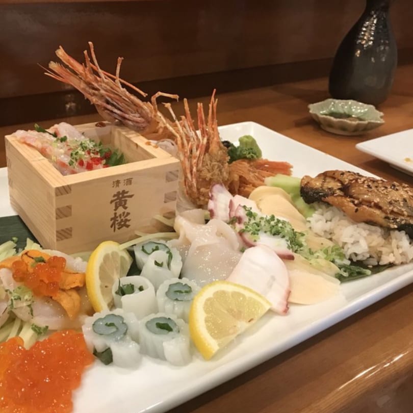 A large platter of Kenzo Thai & Sushi's sushi and sashimi, including shrimp, squid, and fish.