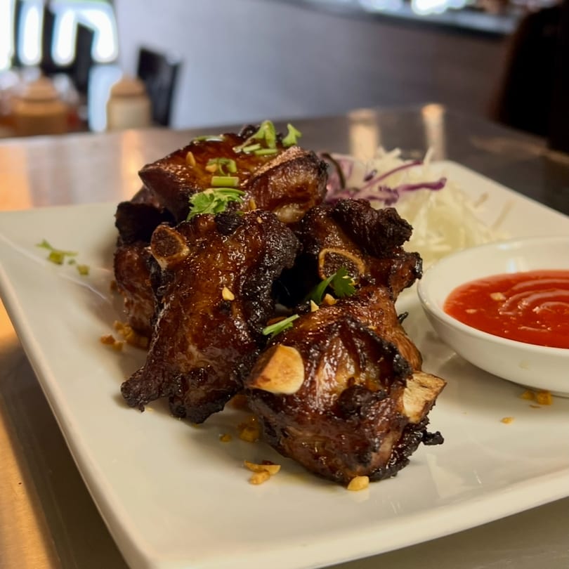 Kenzo Thai & Sushi's grilled pork ribs with cilantro, peanuts, shredded cabbage, and sweet chili sauce.