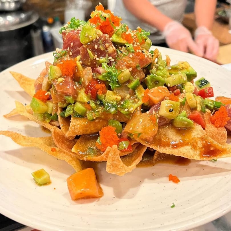 Kenzo Thai & Sushi's poke nachos with tuna, avocado, roe, and sesame seeds on crispy wonton chips.