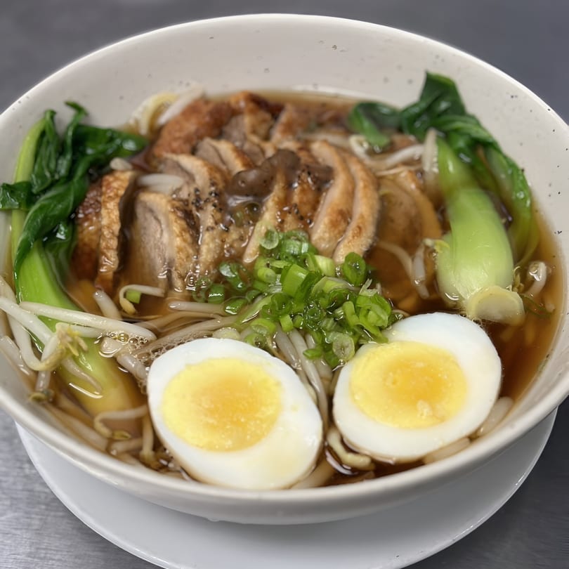 Kenzo Thai & Sushi's ramen bowl with sliced duck, bok choy, bean sprouts, and two soft-boiled eggs.